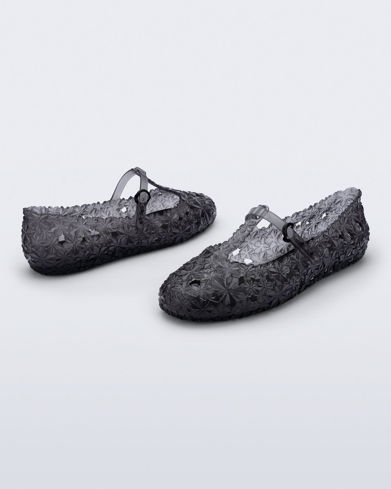 Back and side angled view of a pair of clear black Melissa + Susan Fang Daphnis Ballerinas with t-top strap