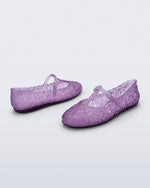 Back and side angled view of a pair of clear lilac Melissa + Susan Fang Daphnis Ballerinas with t-top strap
