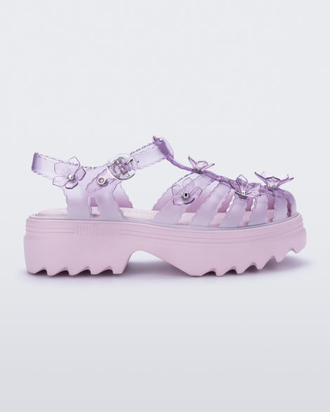 side view of a Clear pink Melissa + Susan Fang Possession Platform Sakura sandal with pink sole