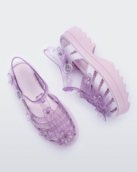 Top and side view of a pair of Clear pink Melissa + Susan Fang Possession Platform Sakura sandals with pink soles
