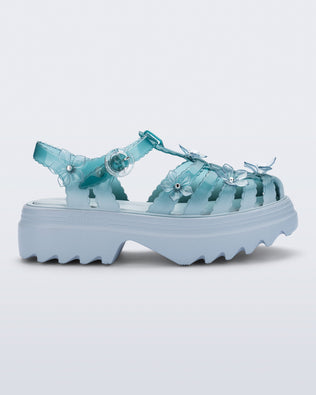 side angled view of a Clear misty blue/green Melissa + Susan Fang Possession Platform Sakura sandal with light blue soles