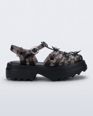 Side view of a Clear black Melissa + Susan Fang Possession Platform Sakura sandal