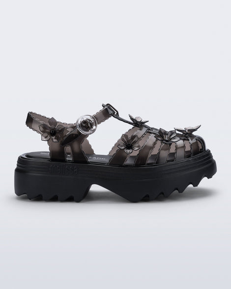 Side view of a Clear black Melissa + Susan Fang Possession Platform Sakura sandal