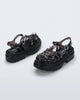 Back and side angled view of a pair of Clear black Melissa + Susan Fang Possession Platform Sakura sandals 