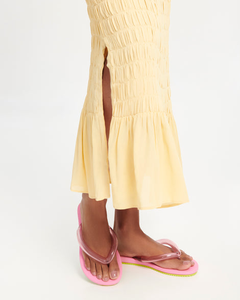 Model's legs wearing a pair of pink Flip Flop Airflow sandal with a clear pink strap and green bottom
