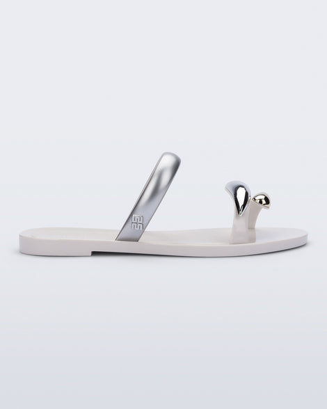 Side view of a white Eden sandal with metallic straps