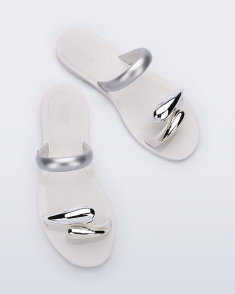 Top view of a pair of white Eden sandals with metallic straps