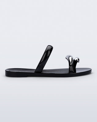Side view of a black Eden sandals with metallic straps