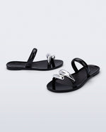 Side and angled view of a pair of black Eden sandals with metallic straps