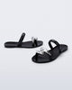 Side and angled view of a pair of black Eden sandals with metallic straps