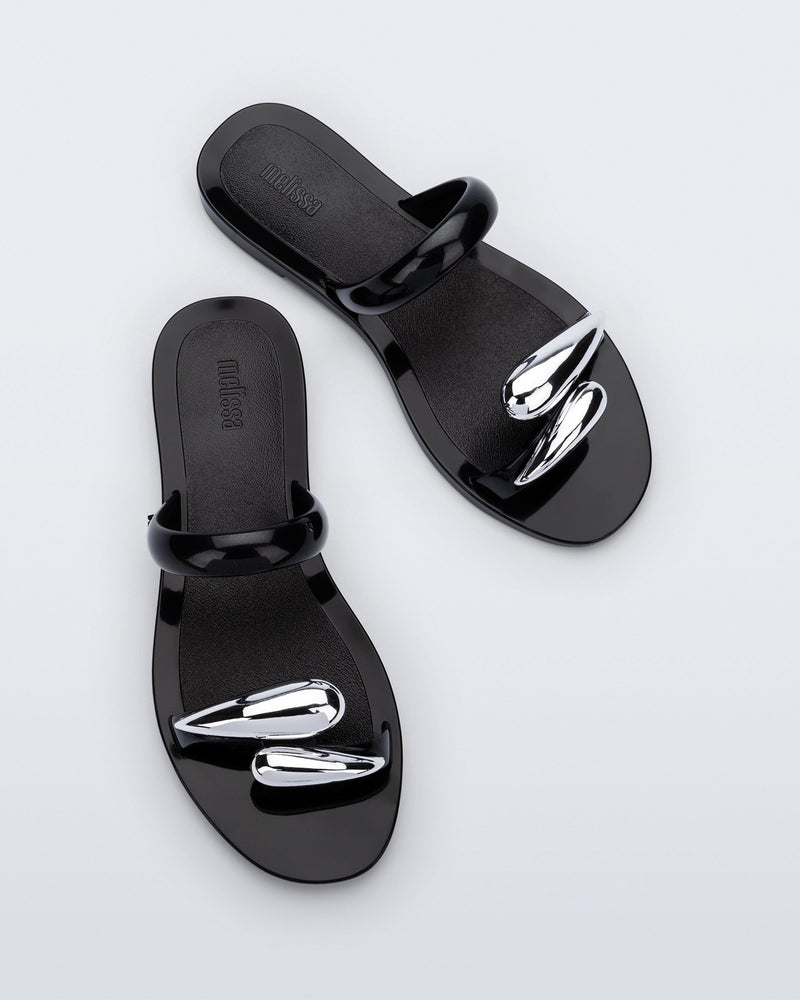 Top view of a pair of black Eden sandals with metallic straps