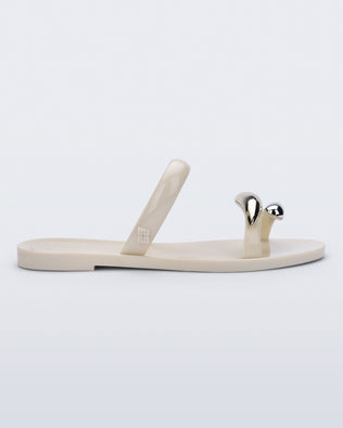 Side view of a beige Eden sandal with metallic straps