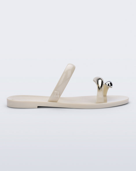 Side view of a beige Eden sandal with metallic straps