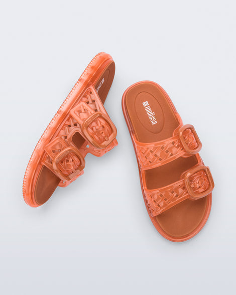 Top and side view of a pair of orange Possession Slip sandals with two straps with buckles