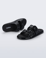 Top and side view of a pair of black Possession Slip sandals with two straps with buckles