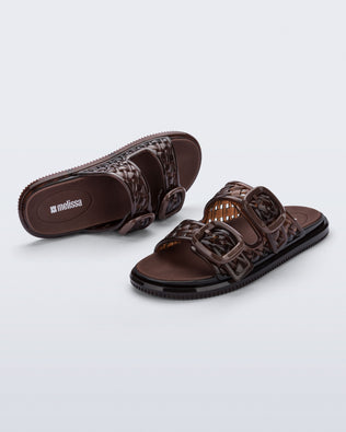 Top and side view of a pair of brown Possession Slip sandals with two straps with buckles