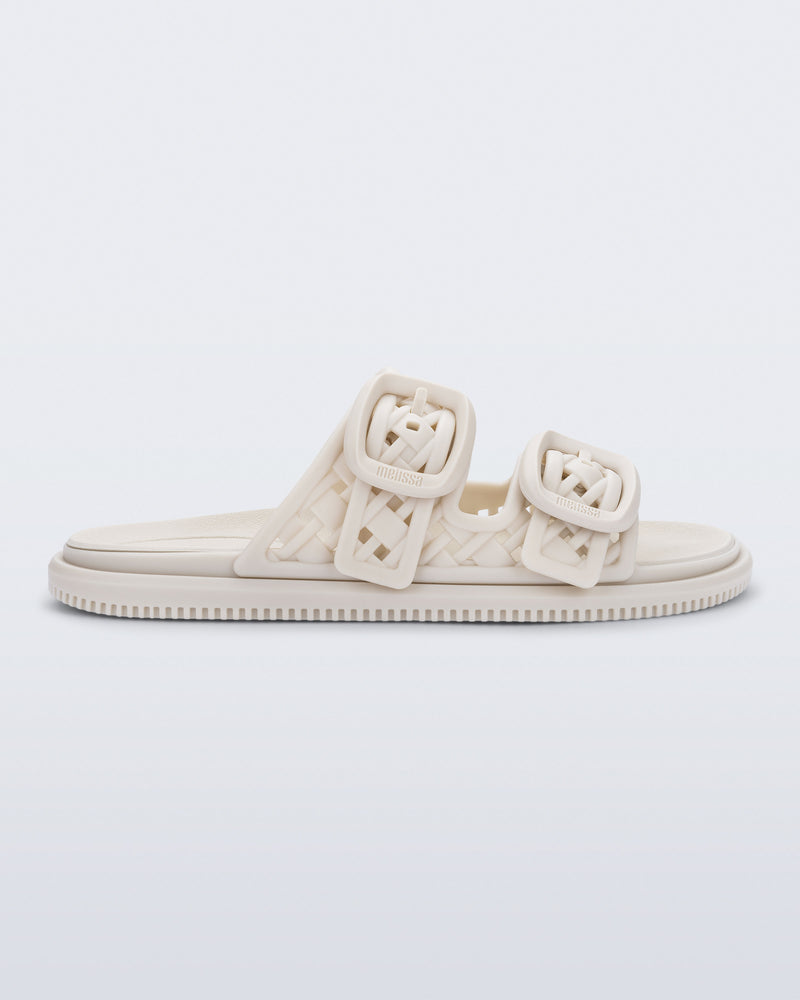 side view of a beige Possession Slip sandal with two straps with buckles