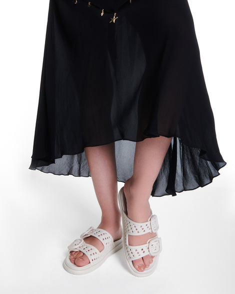 Model's legs wearing a pair of beige Possession Slip sandals with two straps with buckles
