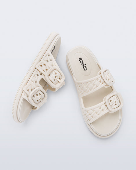 Top and side view of a pair of beige Possession Slip sandals with two straps with buckles