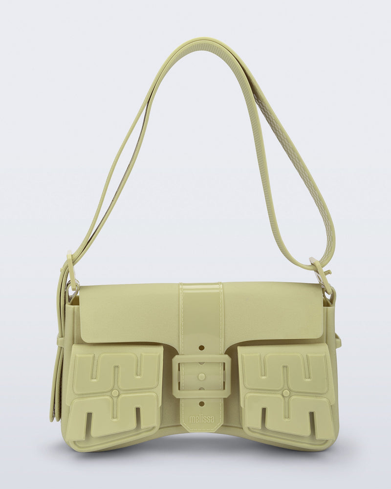 Front view of a pastel green Cargo bag with two small pockets on the front and an adjustable strap