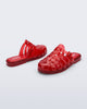 Side and back angled view of a pair of red Possession Mule slides 
