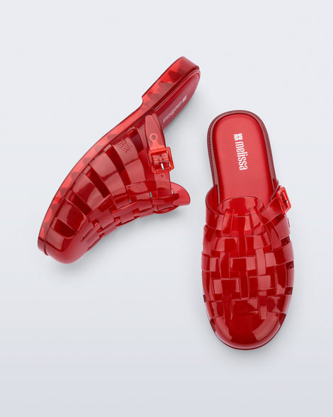 Side and top angled view of a pair of red Possession Mule slides 