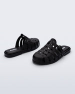 Side and back angled view of a pair of matte black Possession Mule slides 
