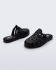 Side and back angled view of a pair of matte black Possession Mule slides 