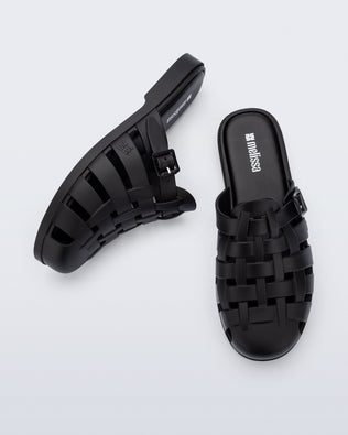 Side and top angled view of a pair of matte black Possession Mule slides 