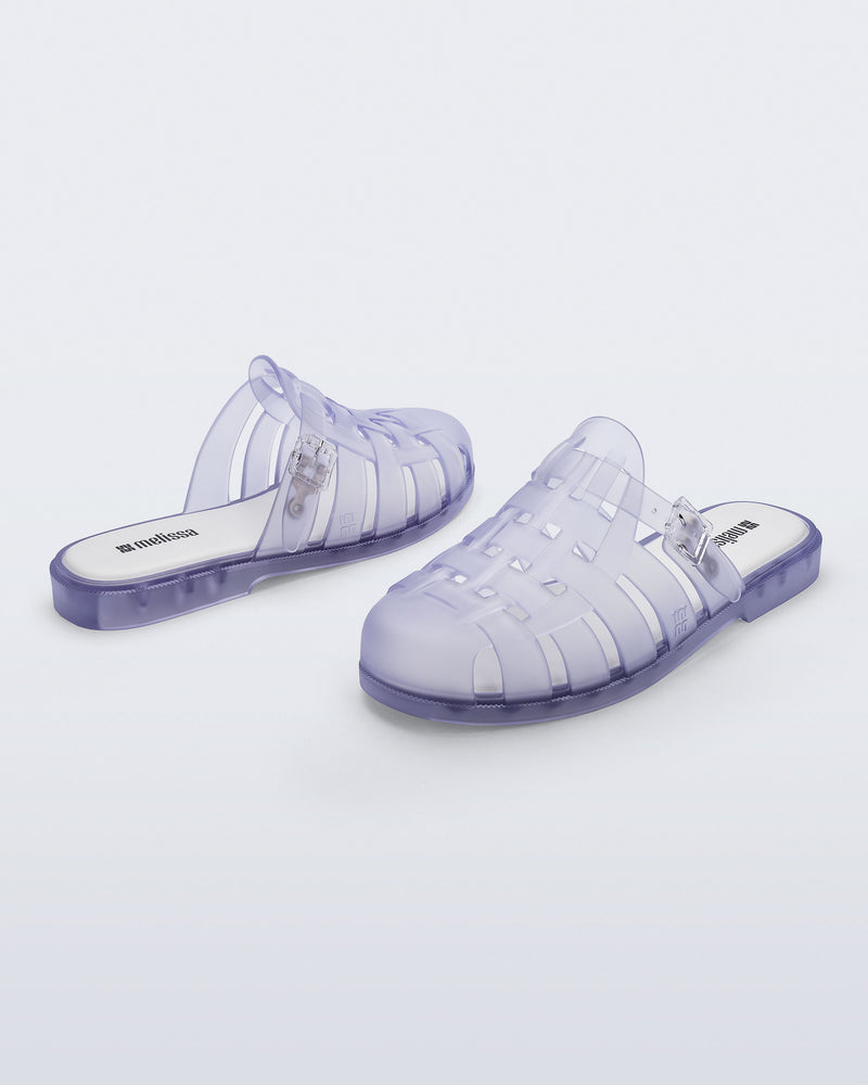 Side and back angled view of a pair of frosted clear Possession Mule slides 