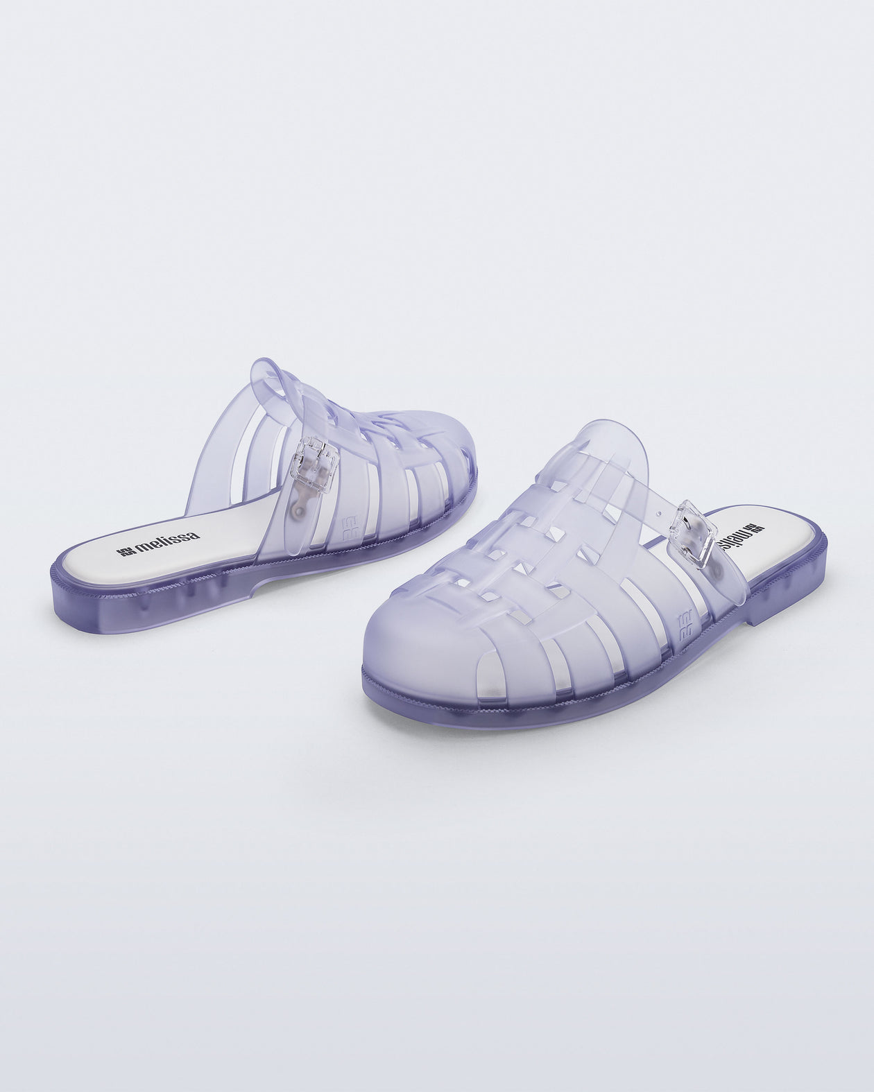 Side and back angled view of a pair of frosted clear Possession Mule slides 