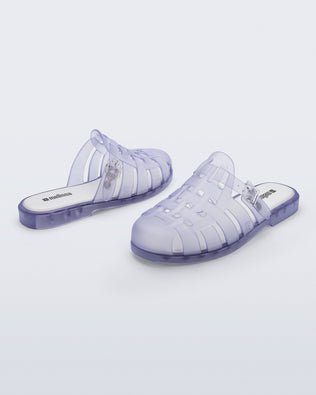 Side and back angled view of a pair of frosted clear Possession Mule slides 