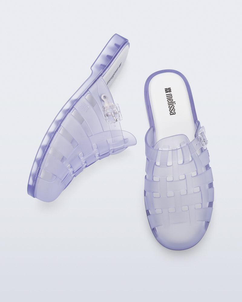 Side and top angled view of a pair of frosted clear Possession Mule slides 