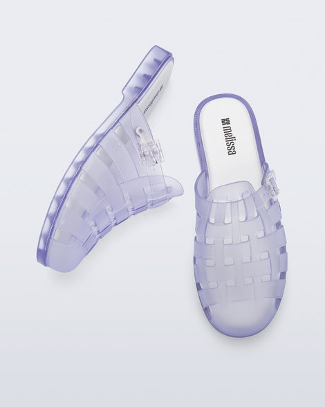 Side and top angled view of a pair of frosted clear Possession Mule slides 