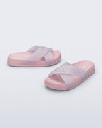 Side and angled view of a pair of light pink Cozy M Lover Slides with Melissa on the upper