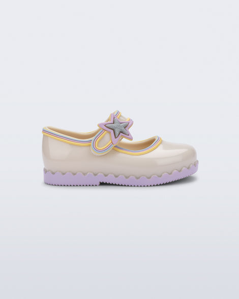 Side view of a beige Hip Ballerina Star baby Mary Jane shoe with lavender soles and star-shaped strap