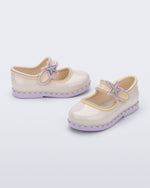 Side and angled view of a pair of beige Hip Ballerina Star baby Mary Jane shoes with lavender soles and star-shaped straps
