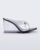 Side view of a clear grey Nabeela wedge flip flop with star charm on the strap