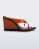 side view of a brown Nabeela wedge flip flop with star charm on strap
