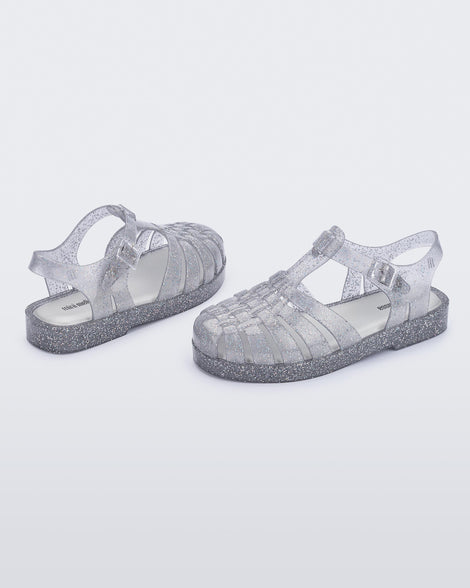 Back and side view of a pair of glitter/clear/silver Possession kids fisherman sandals