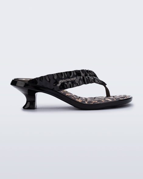 side view of a black Flip Flop Kitten Heel + GANNI sandal with leopard print foot bed and faux ruffle strap