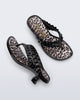 Top and side view of a pair of black Flip Flop Kitten Heel + GANNI sandals with leopard print foot bed and faux ruffle strap