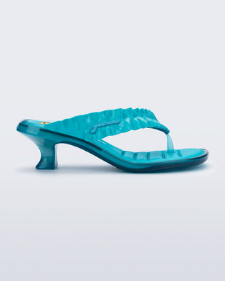 side view of a blue Flip Flop Kitten Heel + GANNI sanda with Banana print foot bed and faux ruffle strap