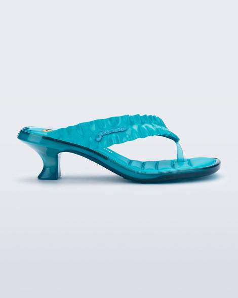 side view of a blue Flip Flop Kitten Heel + GANNI sanda with Banana print foot bed and faux ruffle strap