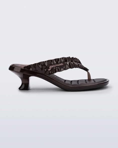 Side view of a brown Flip Flop Kitten Heel + GANNI sandal with strawberry print foot bed and faux ruffle strap