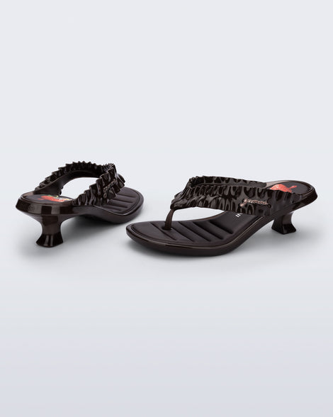 Back and side view of a pair of brown Flip Flop Kitten Heel + GANNI sandals with strawberry print foot bed and faux ruffle strap
