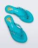 Top view of a pair of blue Flip Flop Slim + GANNI sandals with a banana print foot bed and faux ruffle strap
