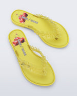Top view of a pair of yellow Flip Flop Slim + GANNI sandals with a cherry print foot bed and faux ruffle strap