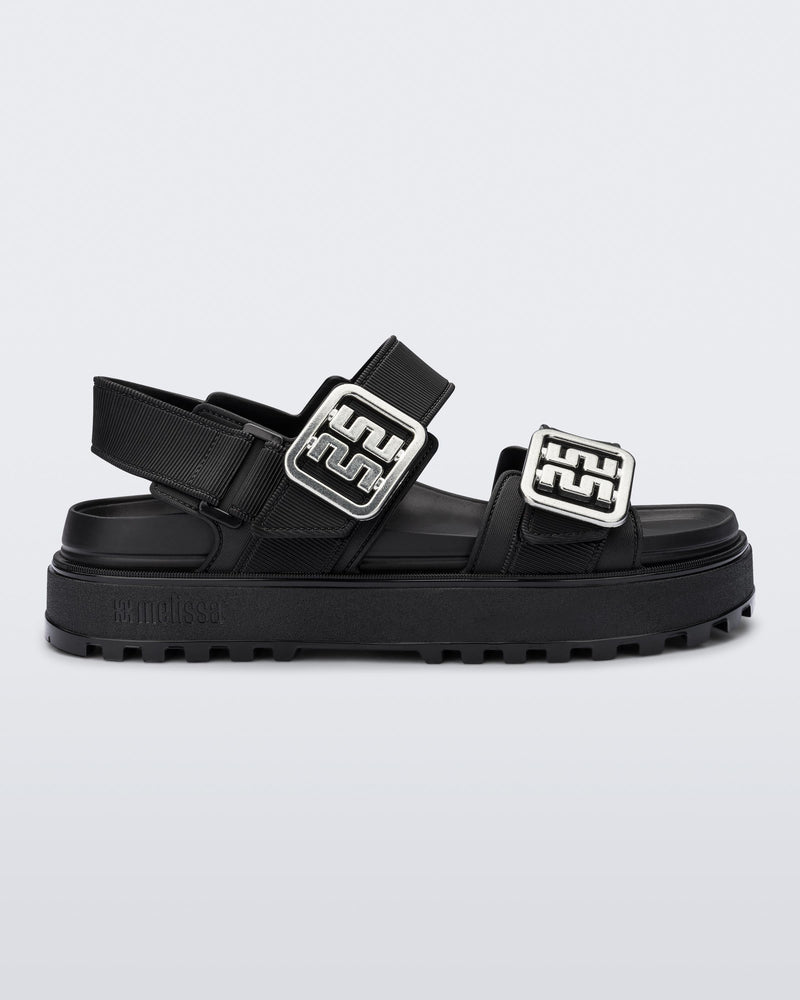 Side view of a black Towny sandal with straps and silver buckle