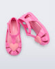 Side and top view of a pair of pink Hip Heart Ballerina baby sandals with heart on front